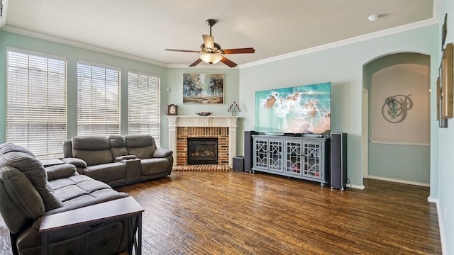 202 Beacon Hill Ln, Forney, TX 75126 - living area with ceiling fan, ornamental molding, a fireplace, arched walkways, and wood finished floors