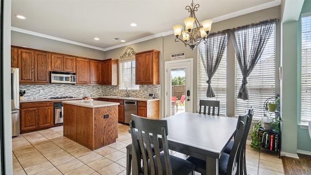 202 Beacon Hill Ln, Forney, TX 75126 - kitchen with stainless steel appliances, tasteful backsplash, a center island, a chandelier, and brown cabinetry