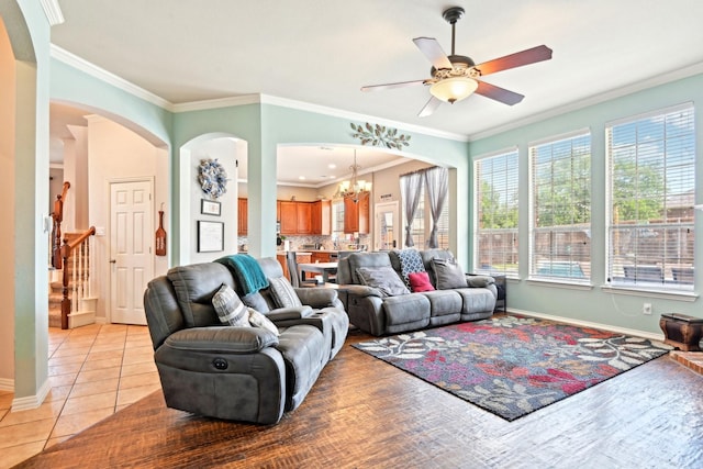 202 Beacon Hill Ln, Forney, TX 75126 - living area with a chandelier, a ceiling fan, arched walkways, light tile patterned floors, and crown molding