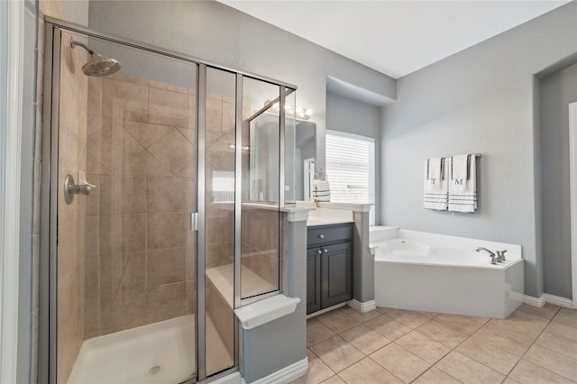 5808 Arabian Dr, Grand Prairie, TX 75052 - bathroom featuring baseboards, tile patterned flooring, a shower stall, a garden tub, and vanity