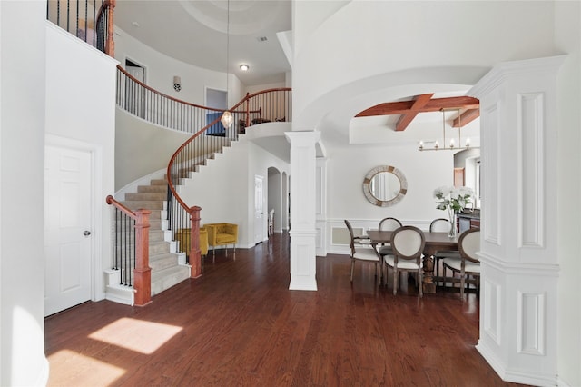 5808 Arabian Dr, Grand Prairie, TX 75052 - entryway featuring stairway, arched walkways, dark wood finished floors, beam ceiling, and ornate columns