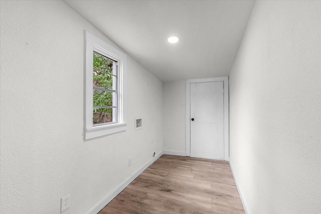 interior space with wood finished floors and baseboards