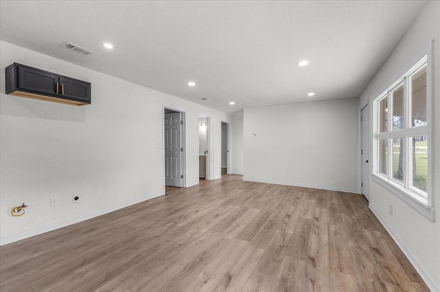 spare room with baseboards, recessed lighting, visible vents, and light wood-type flooring