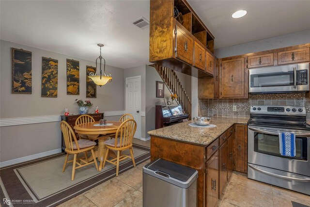 kitchen featuring visible vents, backsplash, light stone countertops, brown cabinetry, and appliances with stainless steel finishes