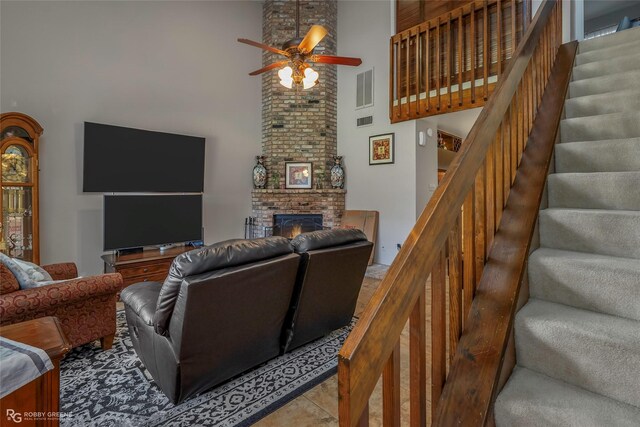 living area featuring high vaulted ceiling, baseboards, a ceiling fan, and stairs