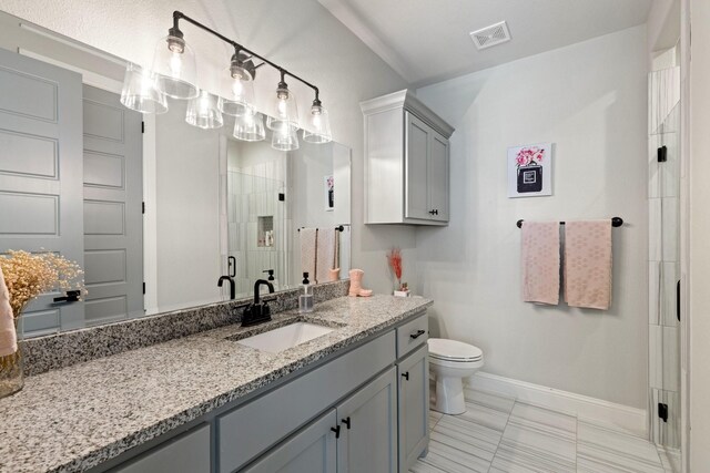 bathroom featuring a shower stall, visible vents, toilet, vanity, and baseboards