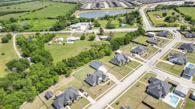 drone / aerial view with a residential view and a water view