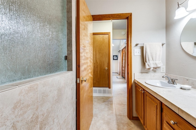 bathroom with visible vents, tile patterned flooring, and vanity