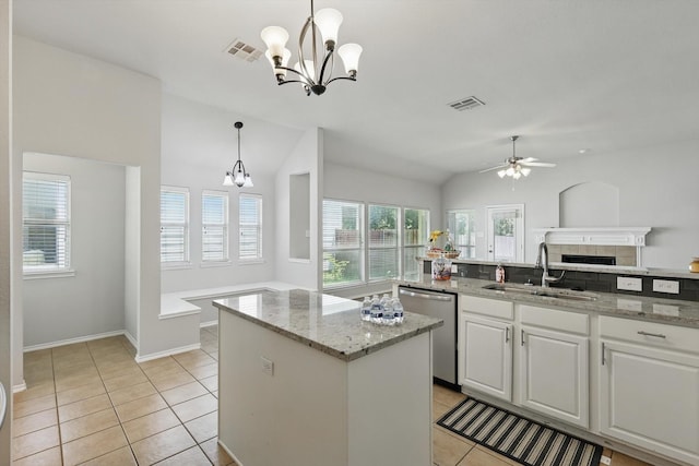 909 Whisper Ln, Mckinney, TX 75072 - kitchen featuring dishwasher, a center island, a chandelier, ceiling fan, and white cabinetry