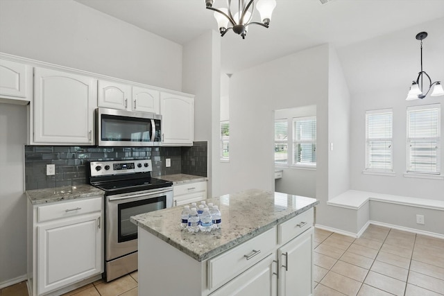 909 Whisper Ln, Mckinney, TX 75072 - kitchen with appliances with stainless steel finishes, a chandelier, decorative backsplash, light stone countertops, and light tile patterned flooring