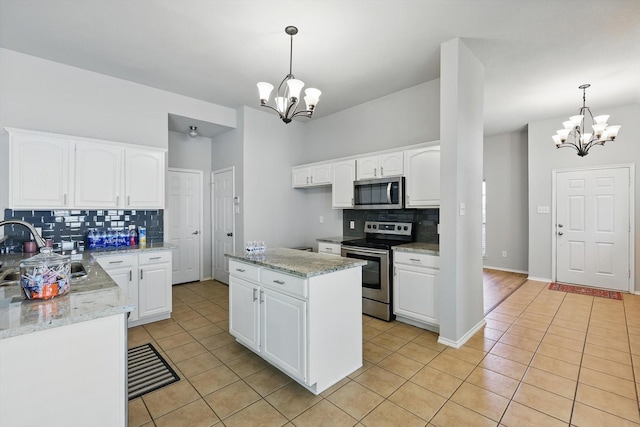 909 Whisper Ln, Mckinney, TX 75072 - kitchen with stainless steel appliances, a chandelier, and light tile patterned flooring