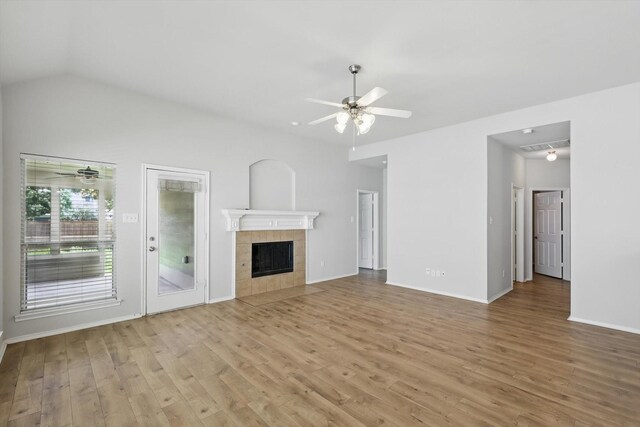 909 Whisper Ln, Mckinney, TX 75072 - unfurnished living room with a ceiling fan, light wood-type flooring, and a tiled fireplace