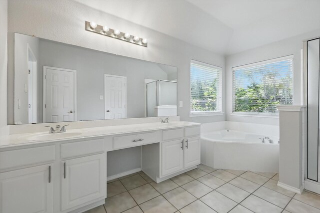 909 Whisper Ln, Mckinney, TX 75072 - full bathroom with double vanity, a garden tub, a shower stall, and tile patterned floors