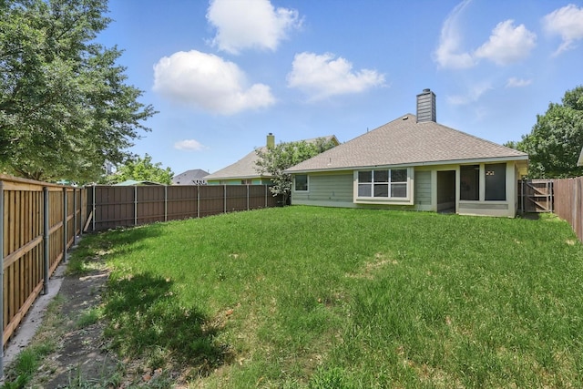 909 Whisper Ln, Mckinney, TX 75072 - back of property with a fenced backyard, roof with shingles, and a chimney