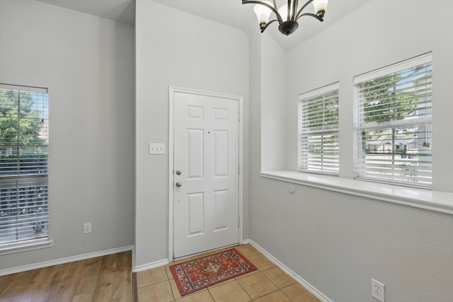 909 Whisper Ln, Mckinney, TX 75072 - foyer with a chandelier, lofted ceiling, and light tile patterned floors