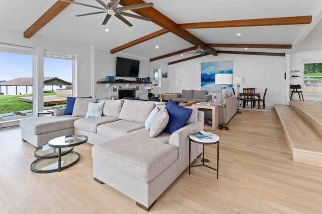 living area featuring ceiling fan, light wood-type flooring, recessed lighting, and vaulted ceiling with beams