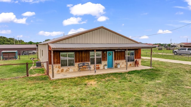 2380 County Road 422, Huckabay, TX 76401 - back of property featuring fence, stone siding, a patio, board and batten siding, and a lawn