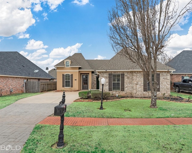 788 Dumaine Dr, Bossier City, LA 71111 - view of front of home with driveway, fence, a front yard, brick siding, and roof with shingles
