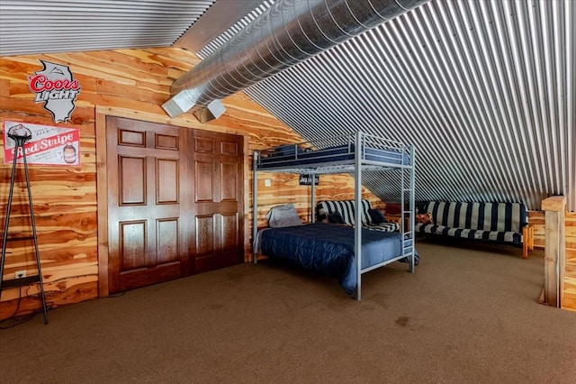 carpeted bedroom featuring wood walls