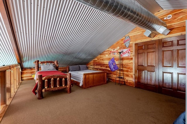 carpeted bedroom featuring wood walls and lofted ceiling