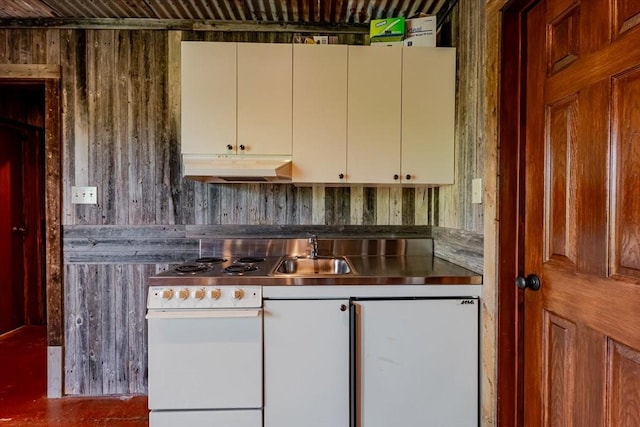 kitchen featuring stainless steel counters, under cabinet range hood, and a sink