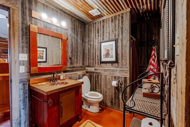 bathroom with vanity, concrete floors, and toilet