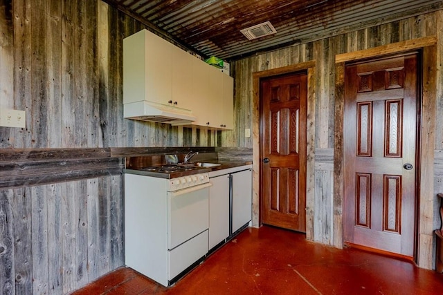 kitchen with white cabinets, under cabinet range hood, visible vents, white range with gas stovetop, and finished concrete floors