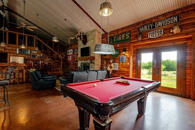 rec room featuring wooden walls, finished concrete flooring, and pool table