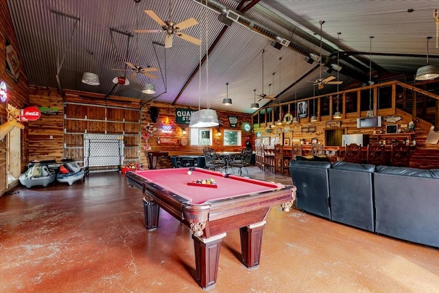 recreation room featuring wood walls, billiards, a ceiling fan, concrete flooring, and high vaulted ceiling