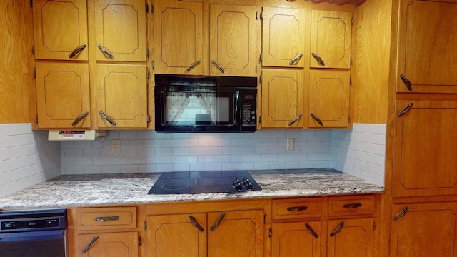kitchen with brown cabinets, tasteful backsplash, and black appliances