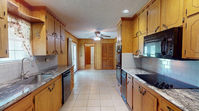 kitchen with a sink, black appliances, tasteful backsplash, a textured ceiling, and ceiling fan