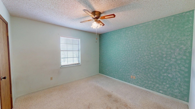spare room featuring carpet flooring and ceiling fan