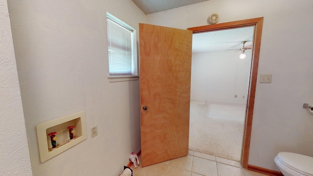 bathroom featuring ceiling fan, toilet, and tile patterned flooring
