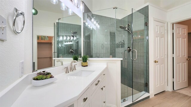 4406 Bay Valley Dr, Garland, TX 75043 - full bath with vanity, wood finished floors, a shower stall, and crown molding