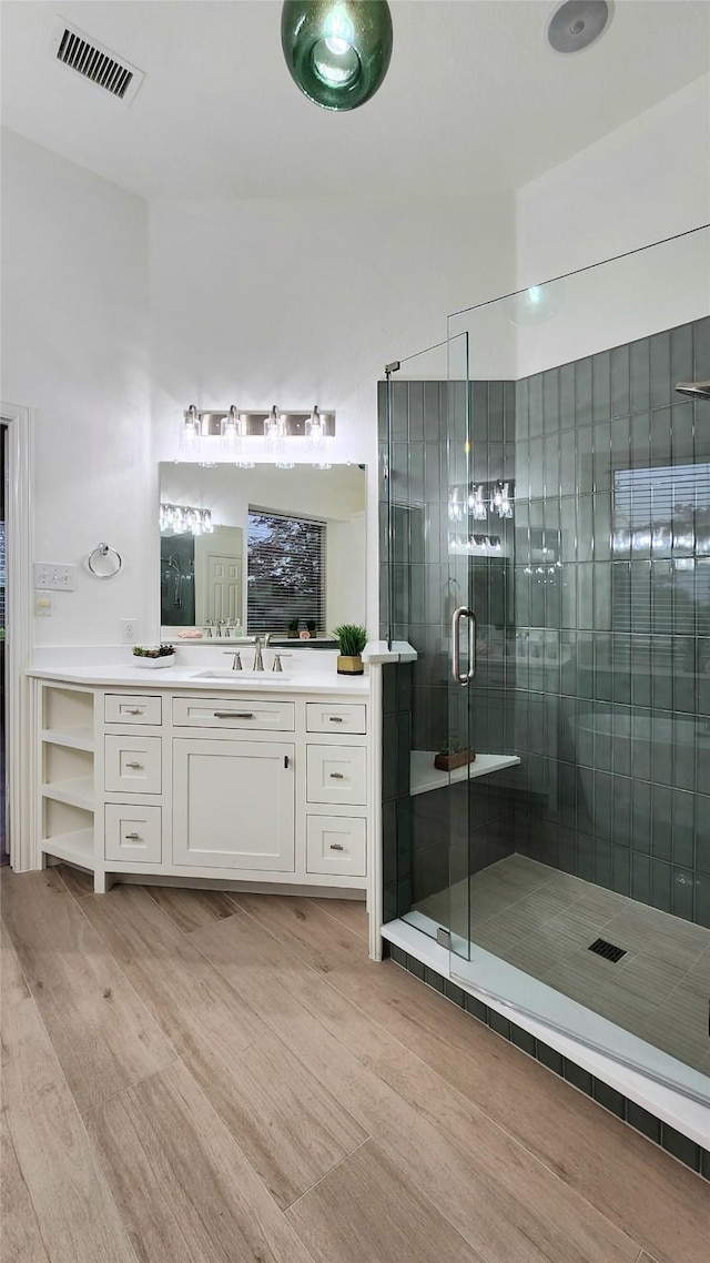 4406 Bay Valley Dr, Garland, TX 75043 - full bathroom with a shower stall, visible vents, vanity, and wood finished floors