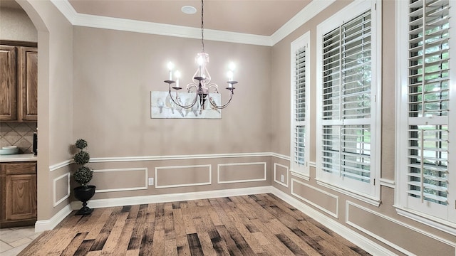 4406 Bay Valley Dr, Garland, TX 75043 - dining area featuring a wealth of natural light, arched walkways, a chandelier, and ornamental molding