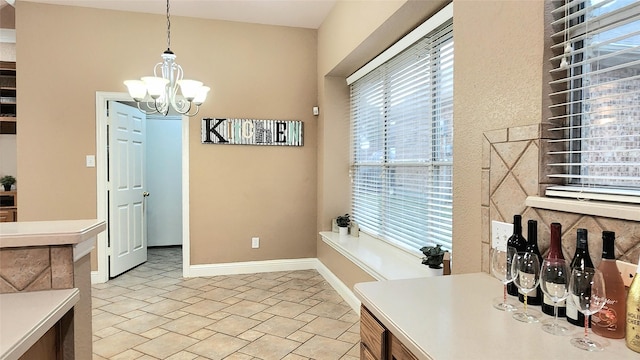 4406 Bay Valley Dr, Garland, TX 75043 - dining space with plenty of natural light, stone finish flooring, baseboards, and a notable chandelier