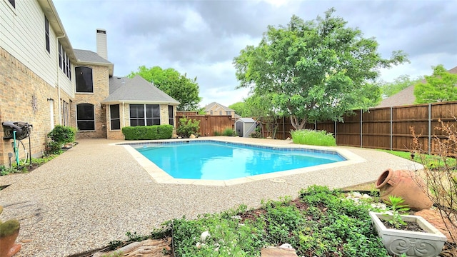 4406 Bay Valley Dr, Garland, TX 75043 - view of swimming pool featuring a storage shed, a fenced in pool, a fenced backyard, an outdoor structure, and a sunroom