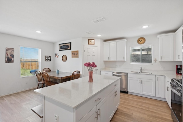 1020 Valerian Dr, Haslet, TX 76052 - kitchen featuring stainless steel dishwasher, a sink, black range with gas cooktop, light wood-type flooring, and recessed lighting