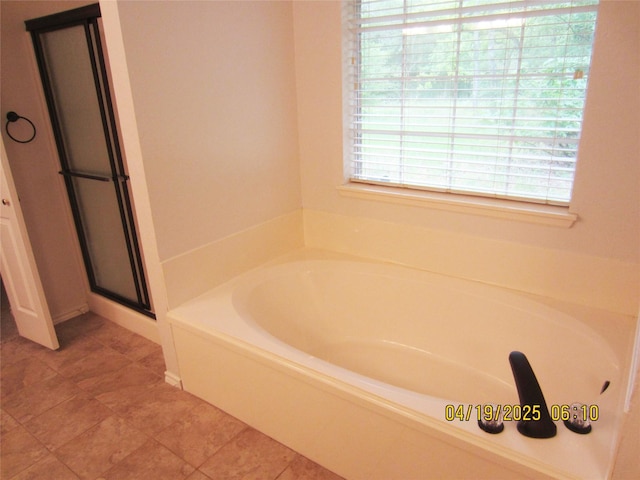 full bathroom with a bath and a stall shower