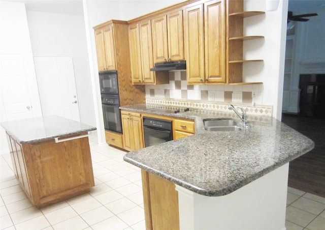kitchen with under cabinet range hood, open shelves, a sink, black appliances, and tasteful backsplash