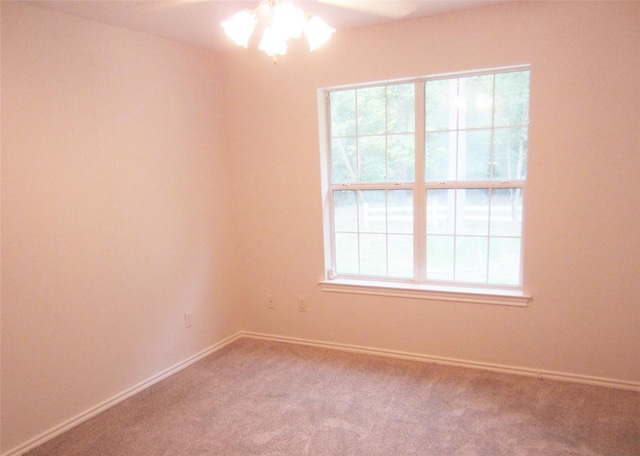 unfurnished room featuring ceiling fan, a wealth of natural light, carpet flooring, and baseboards