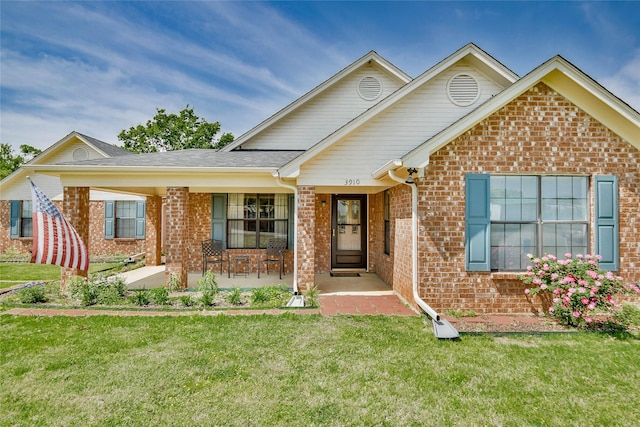 ranch-style home with a front lawn and brick siding