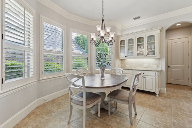 1191 Broken Bend Dr, Prosper, TX 75078 - dining space with a chandelier, crown molding, light tile patterned floors, baseboards, and arched walkways