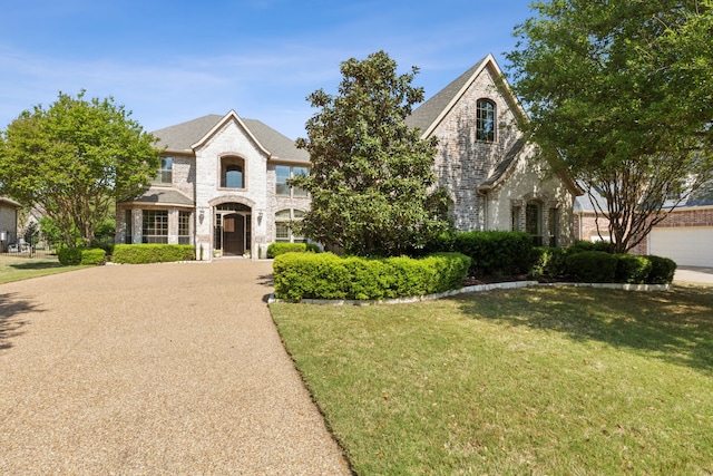 1191 Broken Bend Dr, Prosper, TX 75078 - french provincial home featuring a front lawn and brick siding