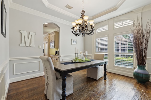 1191 Broken Bend Dr, Prosper, TX 75078 - dining space featuring a decorative wall, arched walkways, a chandelier, dark wood finished floors, and a tray ceiling