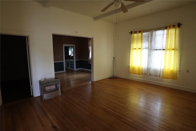 unfurnished living room featuring baseboards, heating unit, wood finished floors, and a ceiling fan