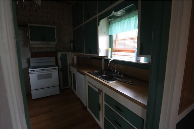 kitchen featuring a sink, butcher block countertops, white appliances, white cabinetry, and dark wood-style floors