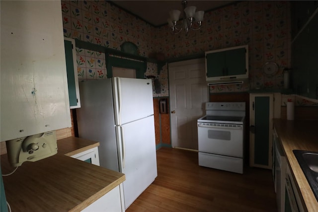 kitchen with wood finished floors, white appliances, a sink, and a notable chandelier