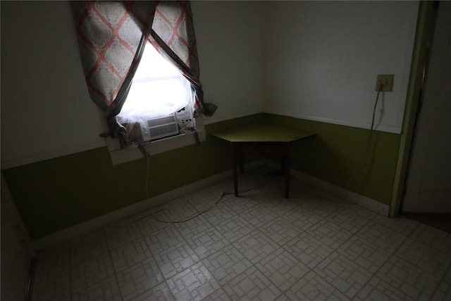 empty room with baseboards and cooling unit